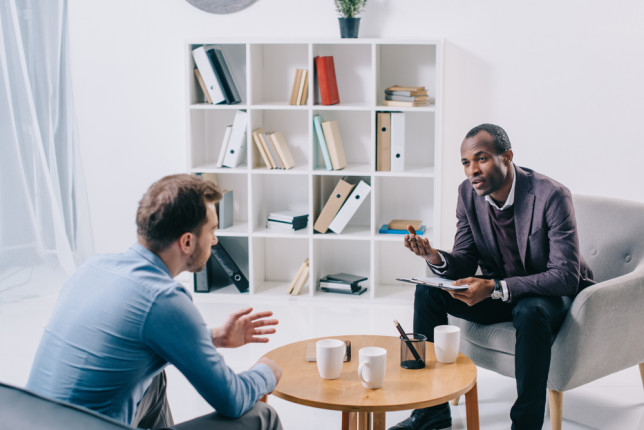 African,American,Psychiatrist,Talking,To,Young,Male,Client